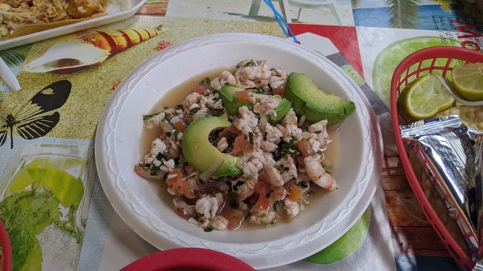 Restaurant menu highlighting carnitas and mariscos.