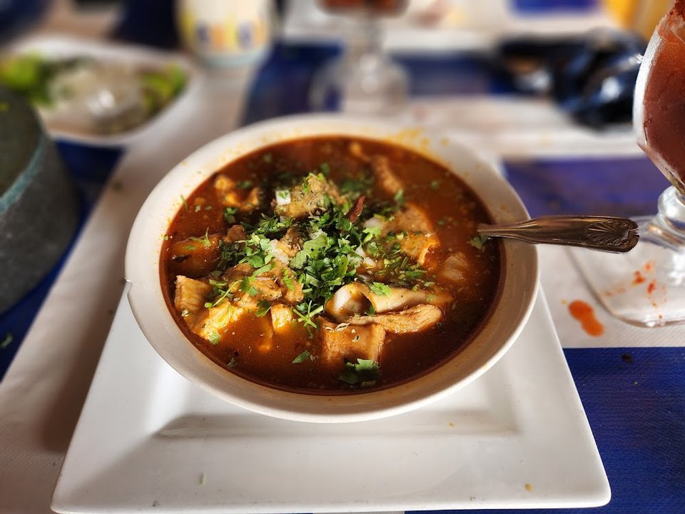 Restaurant menu highlighting carnitas and mariscos.